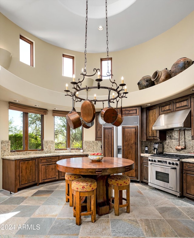 dining space with a towering ceiling and a notable chandelier