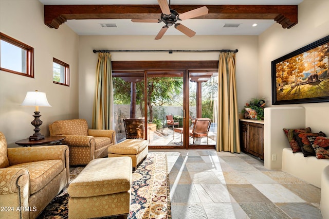 interior space with ceiling fan and beam ceiling