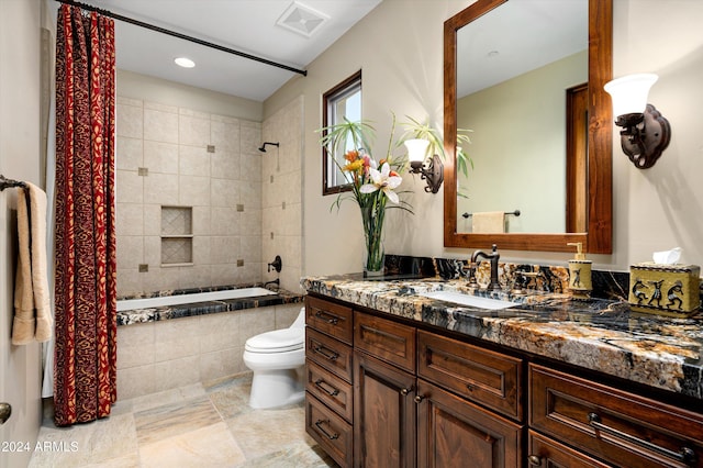 full bathroom featuring shower / tub combo with curtain, vanity, and toilet