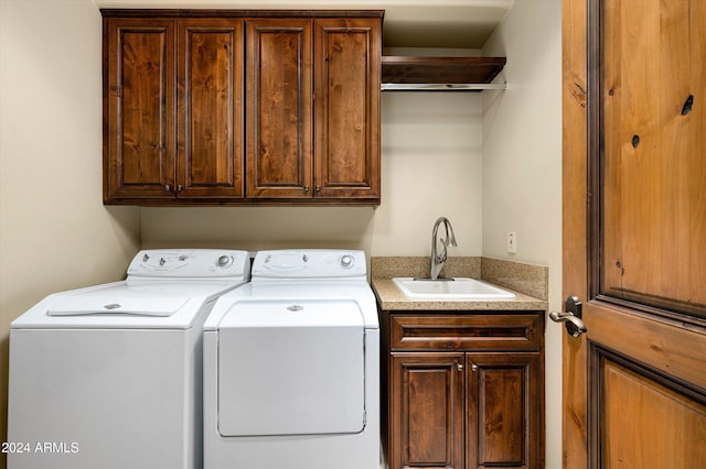 laundry area with cabinets, sink, and independent washer and dryer