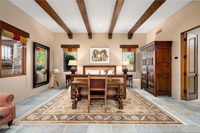 dining space with beam ceiling