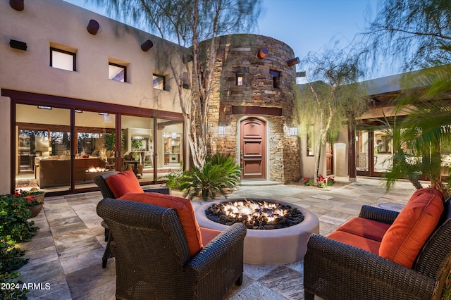 view of patio featuring an outdoor living space with a fire pit