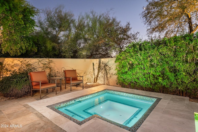 view of swimming pool featuring a patio and an in ground hot tub