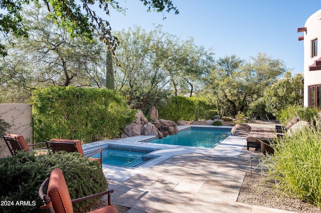 view of pool with a patio area and an in ground hot tub