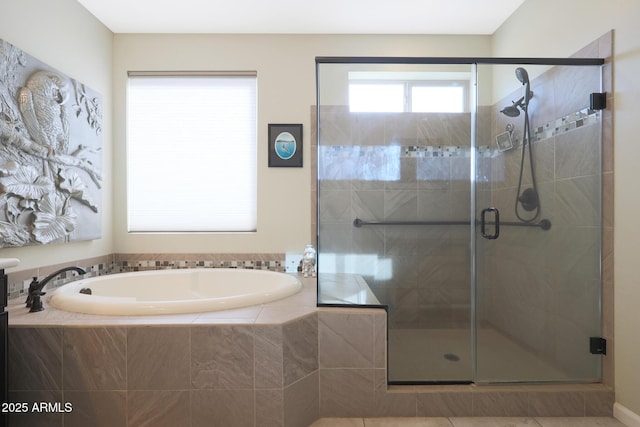 bathroom featuring independent shower and bath