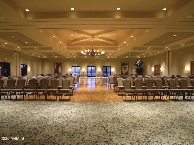 cinema featuring a notable chandelier and wood-type flooring