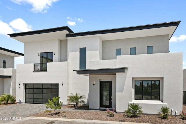 contemporary home with a balcony and a garage