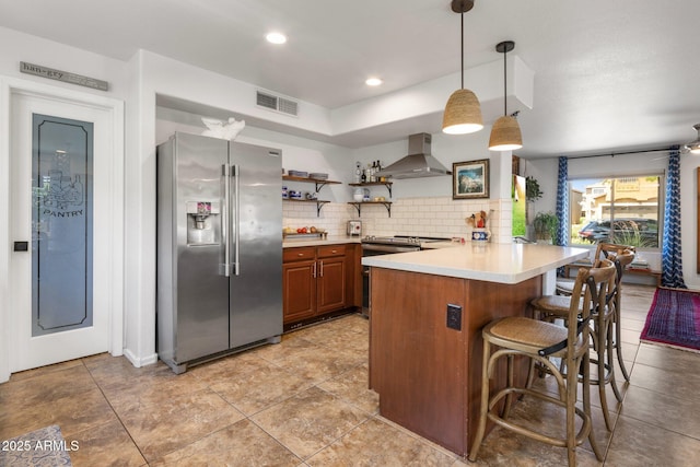 21813 N 40th Way, Phoenix, AZ 85050 - kitchen featuring stainless steel appliances, wall chimney exhaust hood, a peninsula, light countertops, and a breakfast bar area