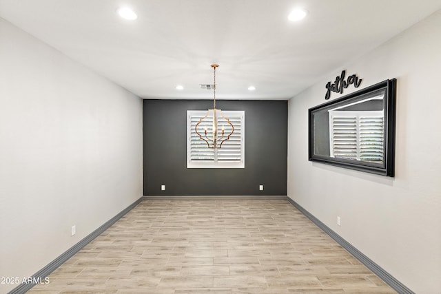 unfurnished room featuring a notable chandelier, recessed lighting, visible vents, and baseboards