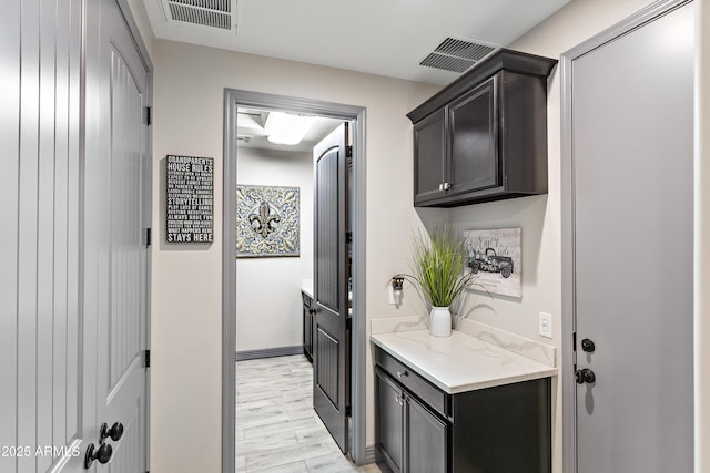 interior space featuring light wood finished floors and visible vents