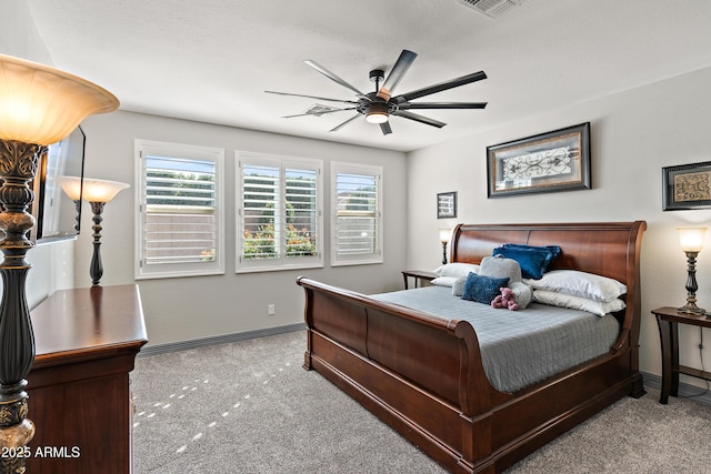 carpeted bedroom featuring ceiling fan, multiple windows, visible vents, and baseboards