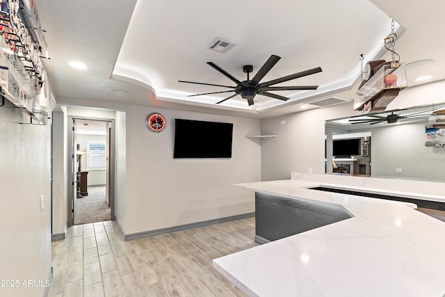 kitchen with ceiling fan, light wood-style flooring, recessed lighting, visible vents, and a tray ceiling