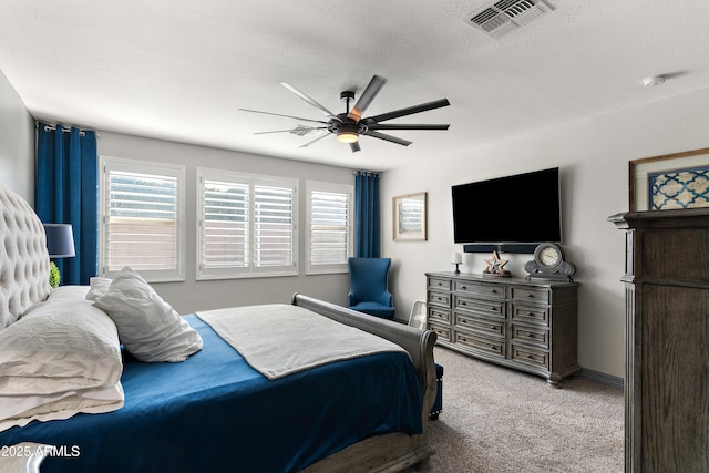 carpeted bedroom with a ceiling fan, visible vents, a textured ceiling, and multiple windows