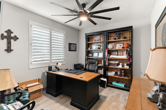 office space featuring ceiling fan and light wood-style floors