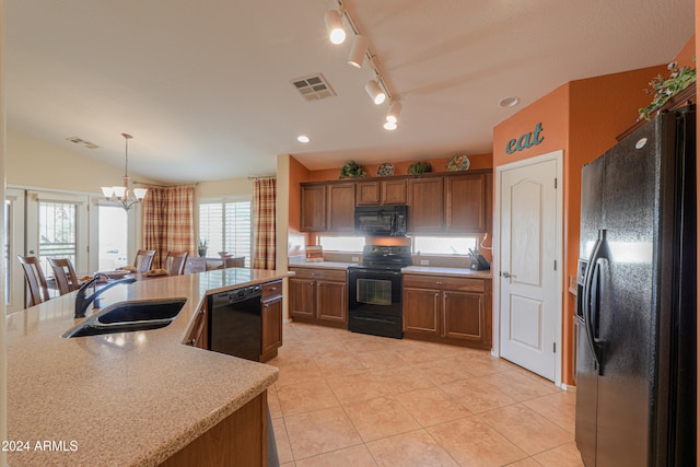 kitchen featuring black appliances, a notable chandelier, a healthy amount of sunlight, and sink