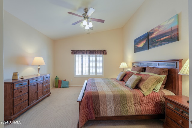 bedroom with ceiling fan, light carpet, and vaulted ceiling