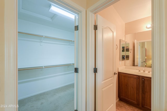 bathroom featuring vanity and vaulted ceiling