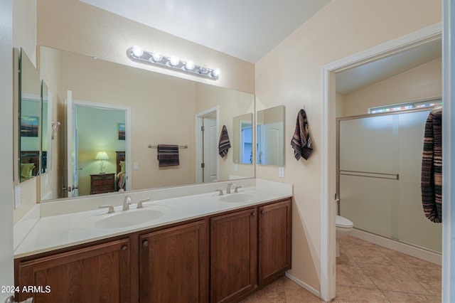 bathroom with walk in shower, tile patterned flooring, vaulted ceiling, toilet, and vanity