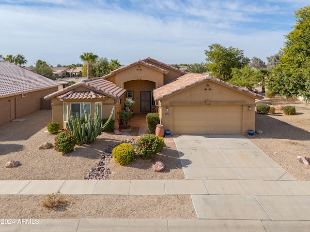 mediterranean / spanish-style home with a garage