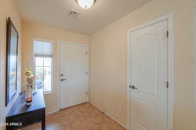 foyer entrance with light tile patterned floors