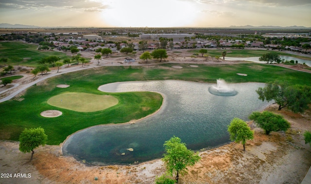 aerial view at dusk featuring a water view