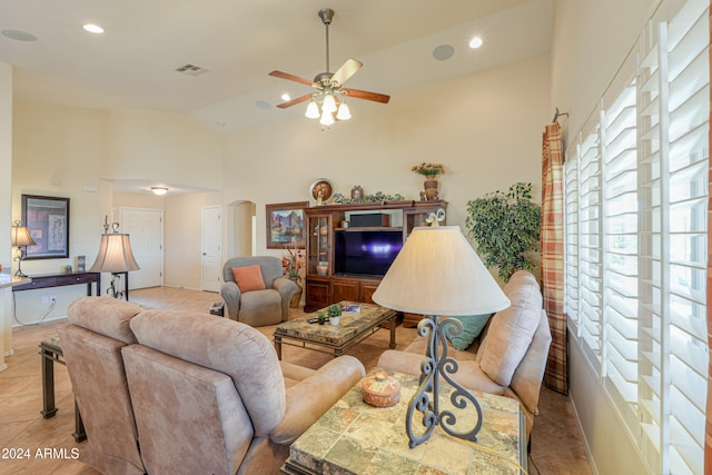 living room with high vaulted ceiling, ceiling fan, and light tile patterned flooring