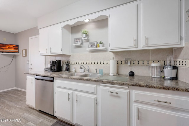 kitchen with backsplash, white cabinetry, light wood-type flooring, dishwasher, and sink