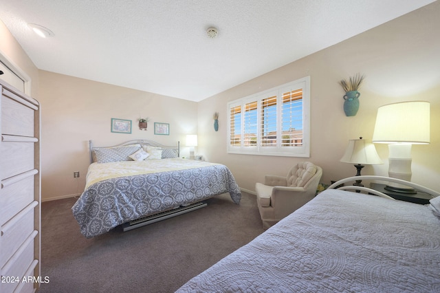 bedroom featuring lofted ceiling, a textured ceiling, and dark carpet