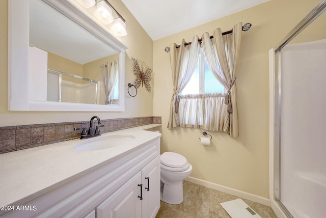 bathroom featuring vanity, tile patterned floors, toilet, and walk in shower