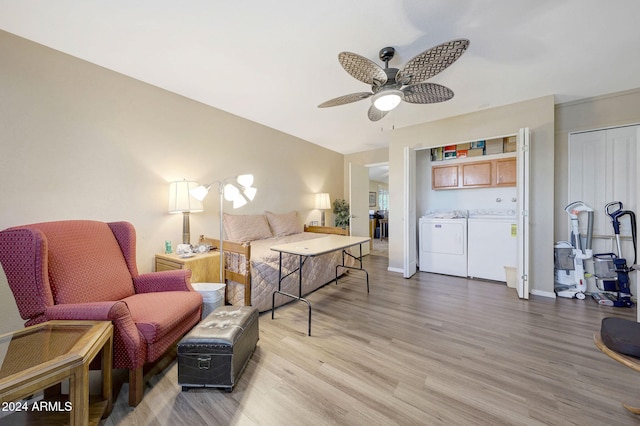 bedroom featuring a closet, ceiling fan, wood-type flooring, and washing machine and clothes dryer