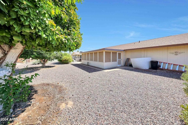 view of property exterior with a sunroom