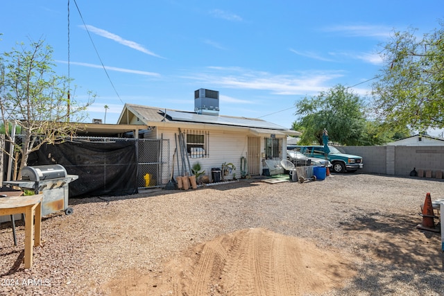 back of property featuring central AC