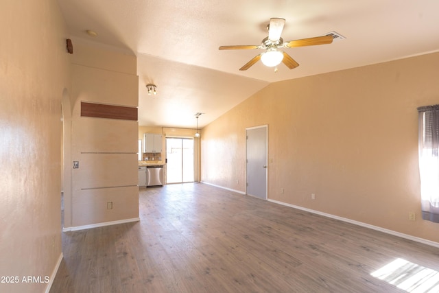 empty room featuring wood-type flooring, lofted ceiling, and ceiling fan