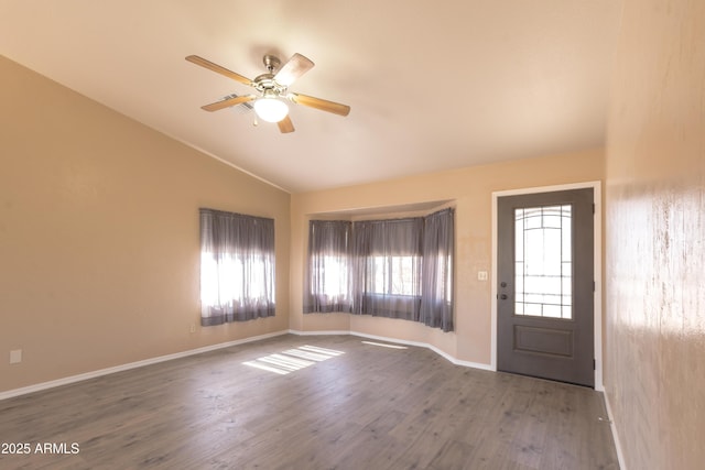 entrance foyer with hardwood / wood-style flooring, ceiling fan, and vaulted ceiling