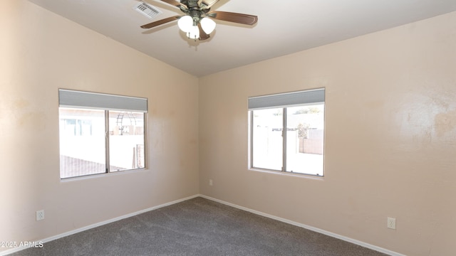 carpeted spare room with vaulted ceiling and ceiling fan