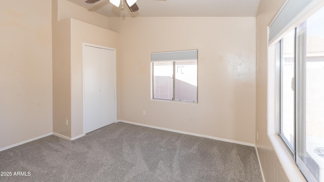 unfurnished room featuring lofted ceiling, carpet flooring, and ceiling fan