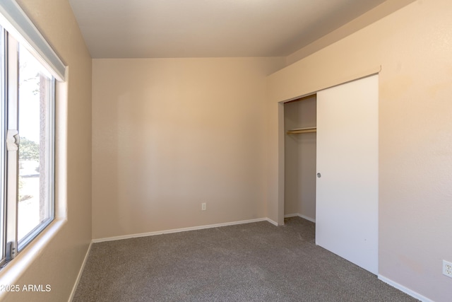 unfurnished bedroom with a closet and carpet flooring