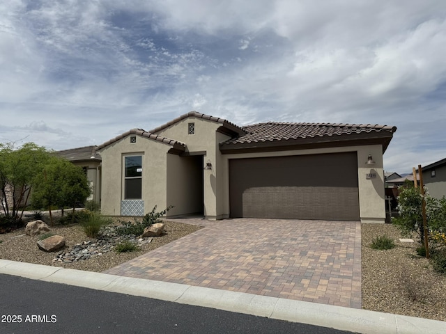 3116 Prospector Way, Wickenburg, AZ 85390 - mediterranean / spanish house featuring stucco siding, decorative driveway, a garage, and a tile roof