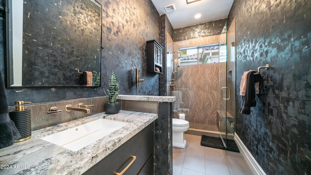 bathroom featuring visible vents, vanity, toilet, tile patterned floors, and a stall shower