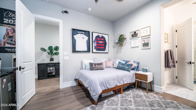 bedroom with baseboards and wood finished floors