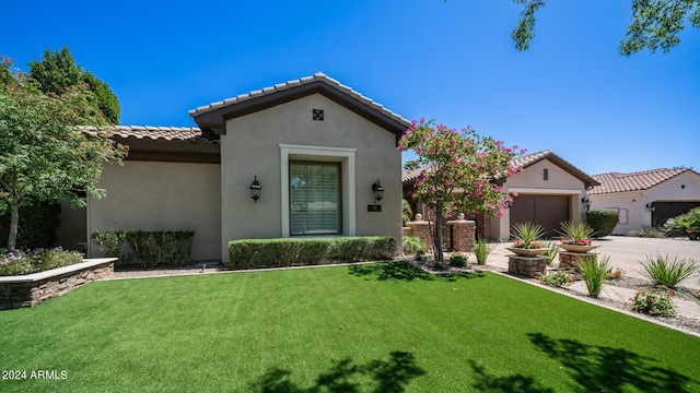 mediterranean / spanish house featuring a garage, a front yard, stucco siding, concrete driveway, and a tile roof