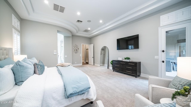 bedroom with visible vents, recessed lighting, a raised ceiling, and light colored carpet