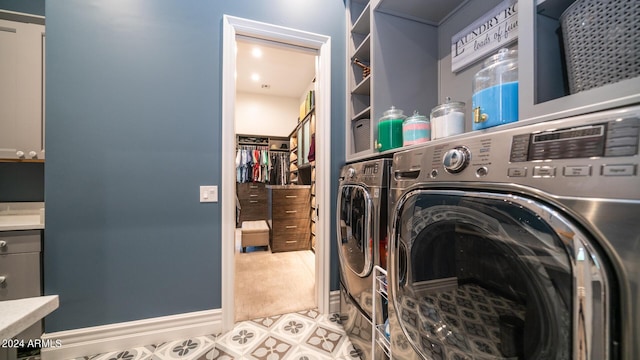 washroom featuring laundry area, tile patterned flooring, carpet floors, and washing machine and dryer
