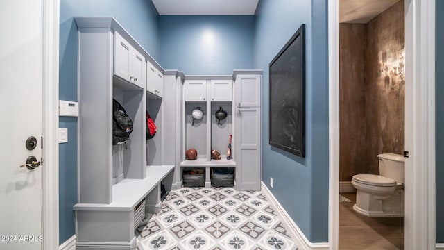 mudroom featuring light floors and baseboards