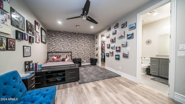 bedroom featuring visible vents, recessed lighting, a ceiling fan, light wood-style flooring, and ensuite bath