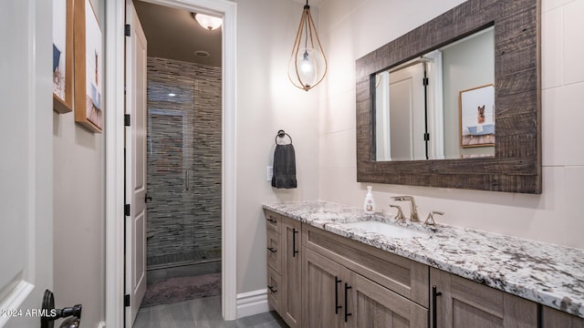 bathroom with vanity, a stall shower, and wood finished floors