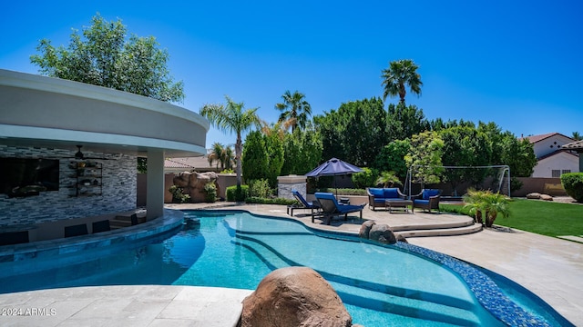 view of pool featuring a patio, a fenced backyard, an outdoor hangout area, a fenced in pool, and a ceiling fan
