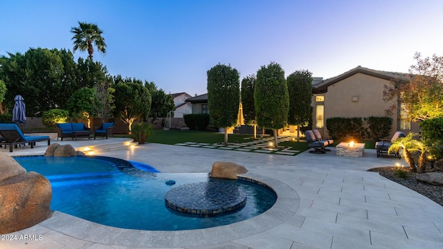 pool at dusk featuring an outdoor living space with a fire pit, a patio area, and an outdoor pool