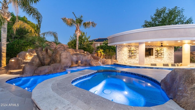 view of pool with an in ground hot tub