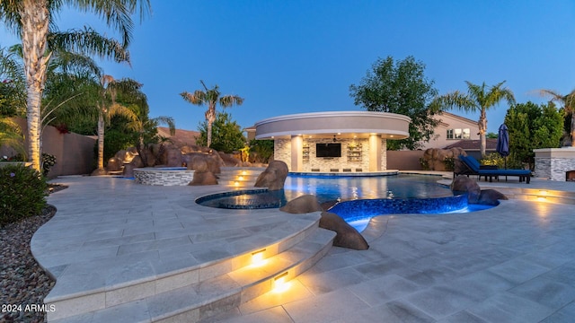 view of pool featuring a fenced in pool, a fenced backyard, an in ground hot tub, and a patio area